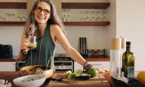 Healthy Senior Woman Smiling While Holding Some Green Juice